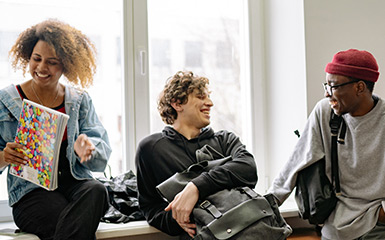 A group of 3 students socialize