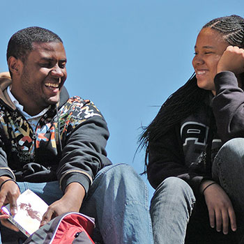 Two students laugh together