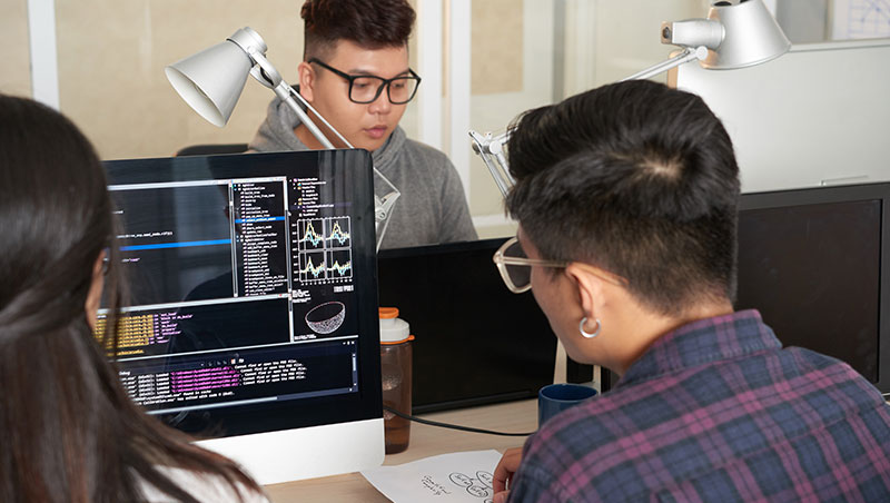 A group of students works on programming and physics problems