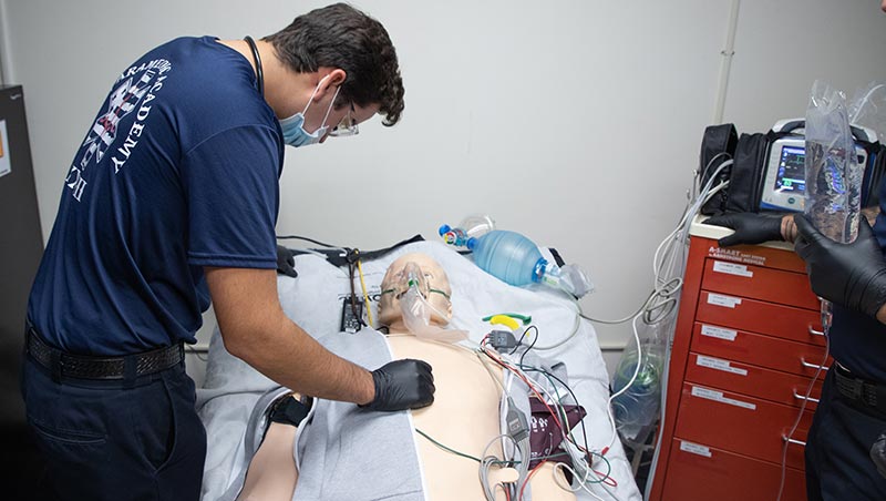 EMS students practice on a medical dummy