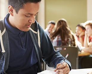 A hispanic student works on homework