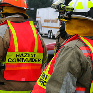 Firefighters in orange vests respond to a disaster