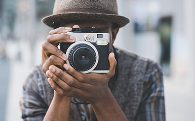 A man holds a camera up to his face