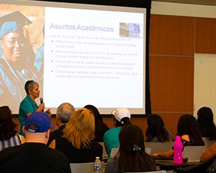 An instructor speaks to the community about student services