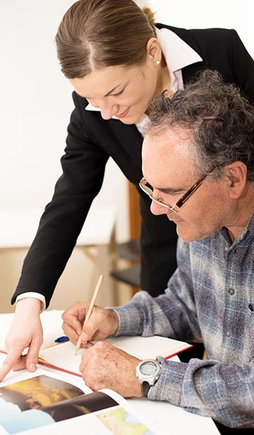 Young teacher explains something to older adult student