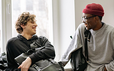 Two students socialize in the hallways