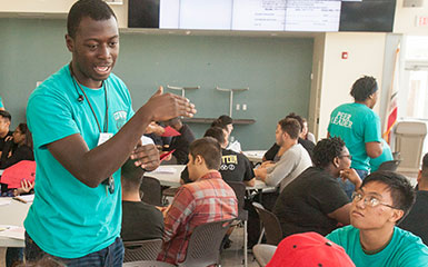 A peer leader speaks to a group of students