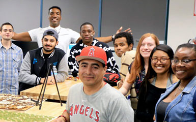 A gathering of iMAKE Innovation Center employees smile at the camera