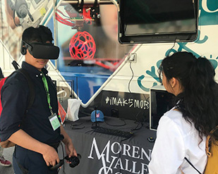 Students try out VR and AR headsets with the iMAKE team