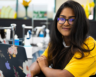 An MVC student work on her laptop in a science classroom