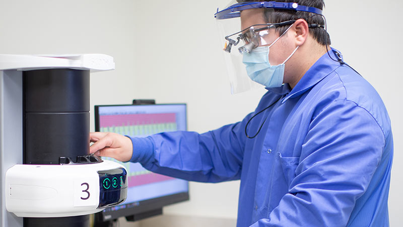 A dental hygiene student works with dental equipment