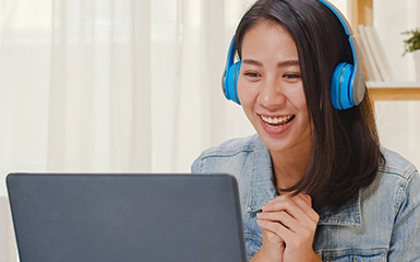 A student chats with student services at a laptop