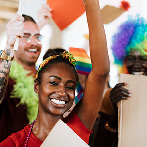 LGBTQIA+ individuals celebrate at a Pride event