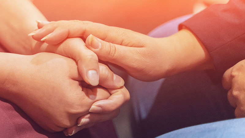 A counselor comforts a patient