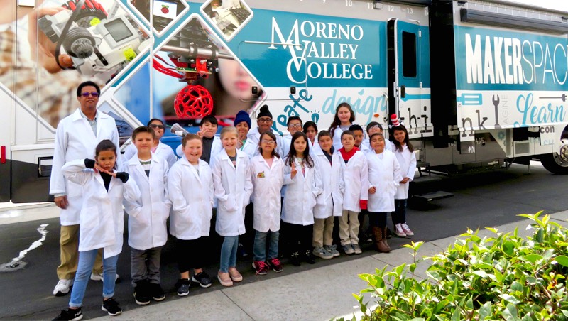 Elementary students next to the iMAKE Mobile Innovation Center