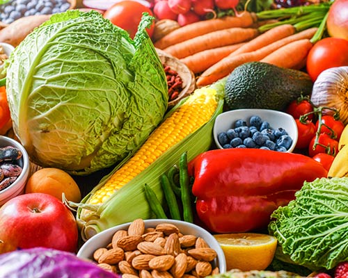 A selection of colorful fruits, vegetables and nuts