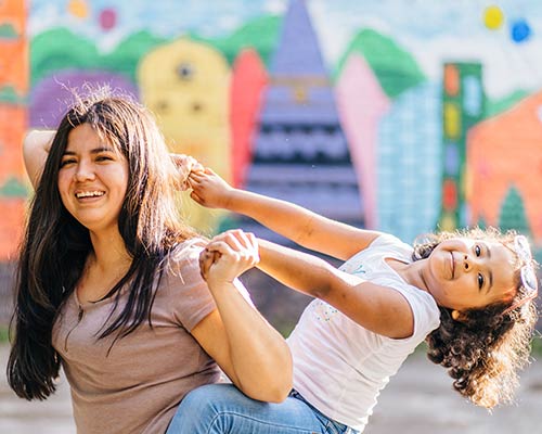 A mother plays with her daughter