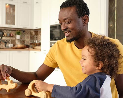 A father plays with his young child