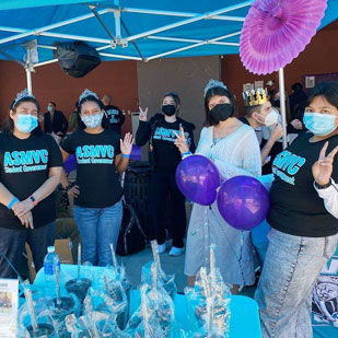 A group of ASMVC students pose together while holding up peace signs