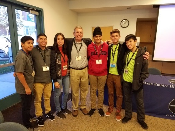 TRIO students pose with college representatives